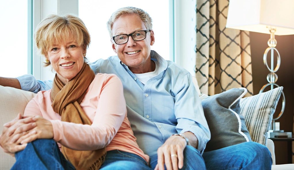 A smiling couple relaxing together on the sofa at home