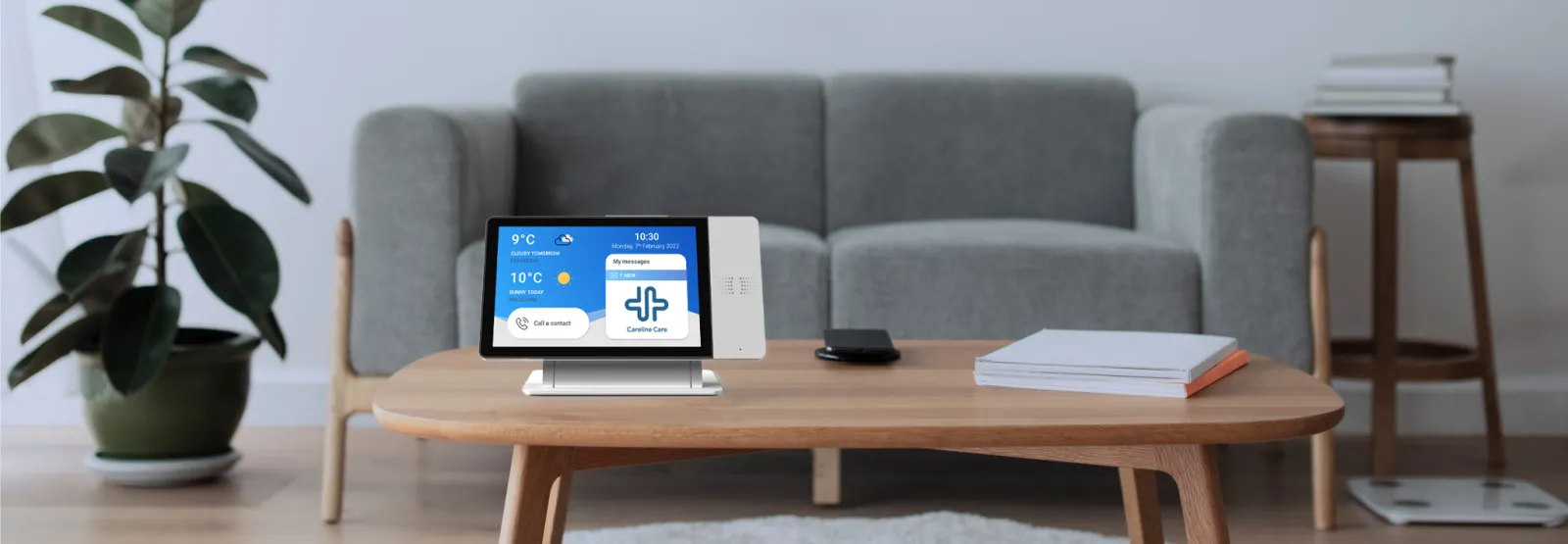 A CareLine Care digital telecare hub on a living room table